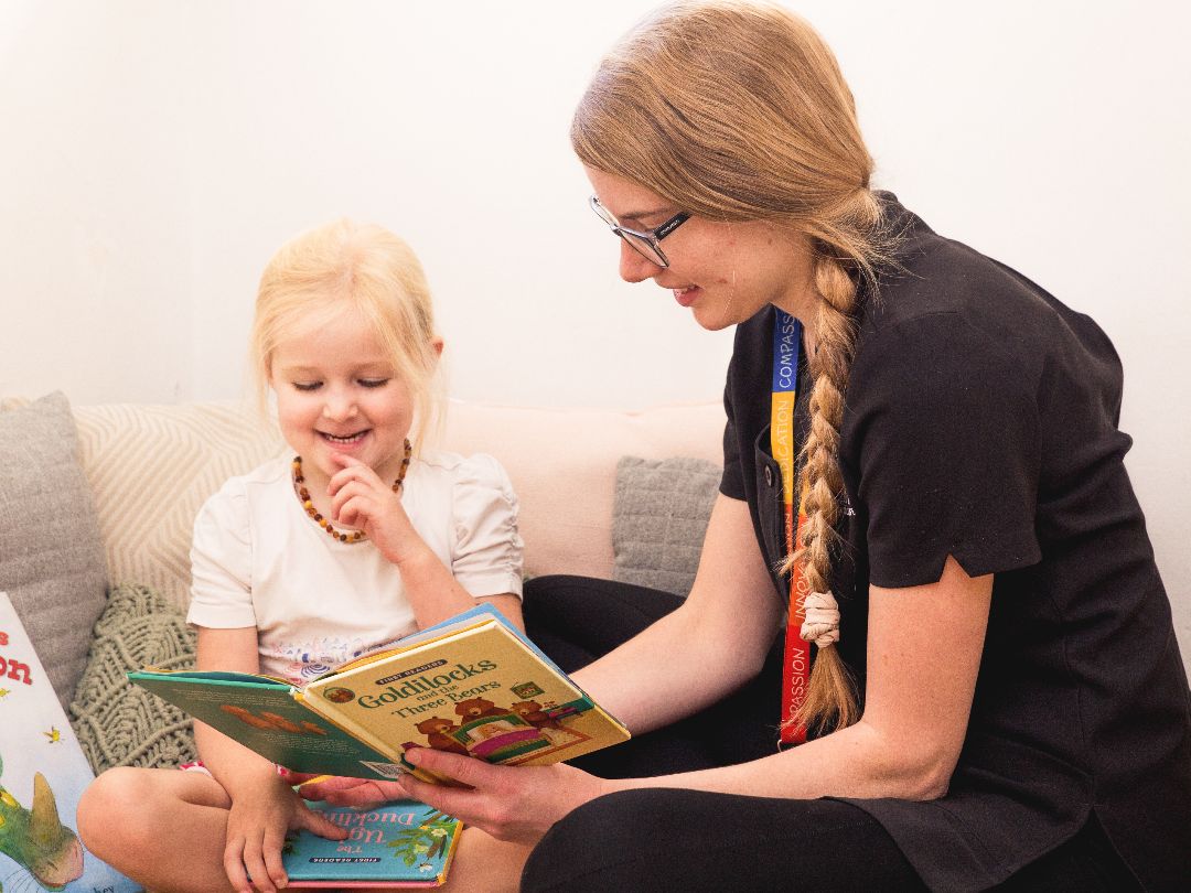 An educator reading to a child