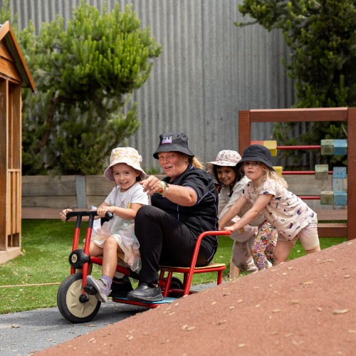 Educator testing out the new centre bike track with children